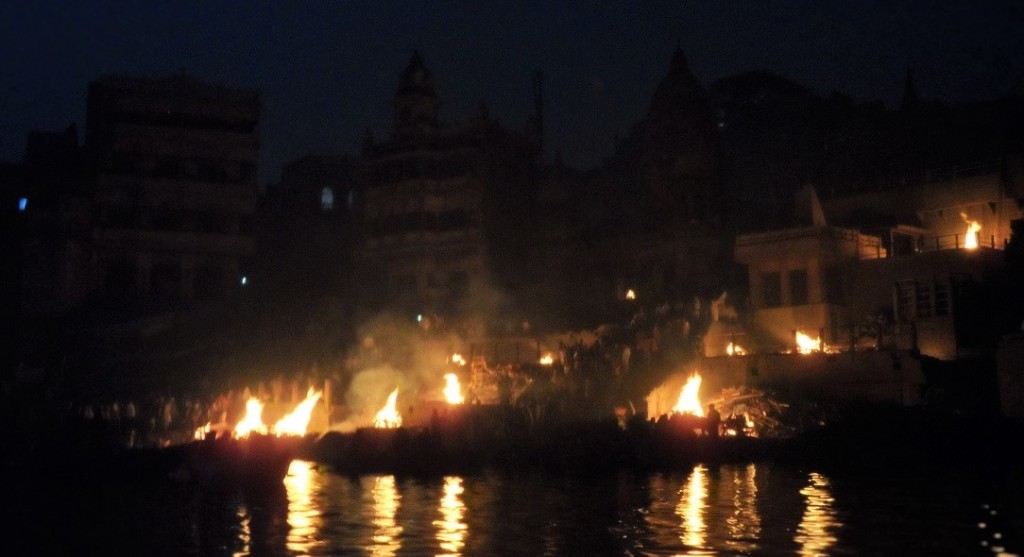 bonfires at night along the Ganges river in Varanasi