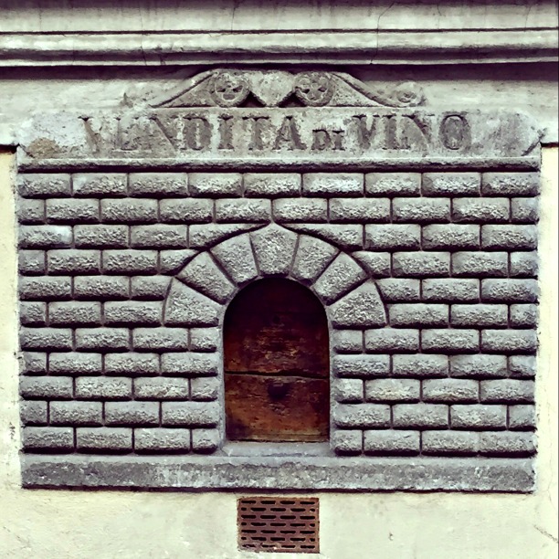 The original, preserved door of a wine bar on the street!