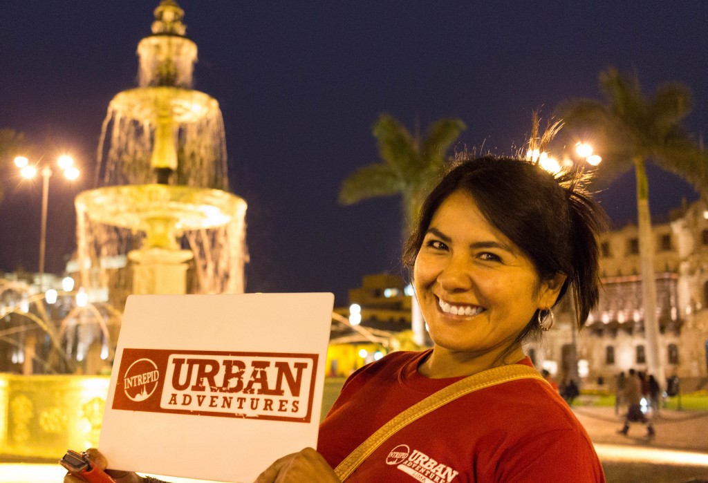 woman holding an Urban Adventures sign