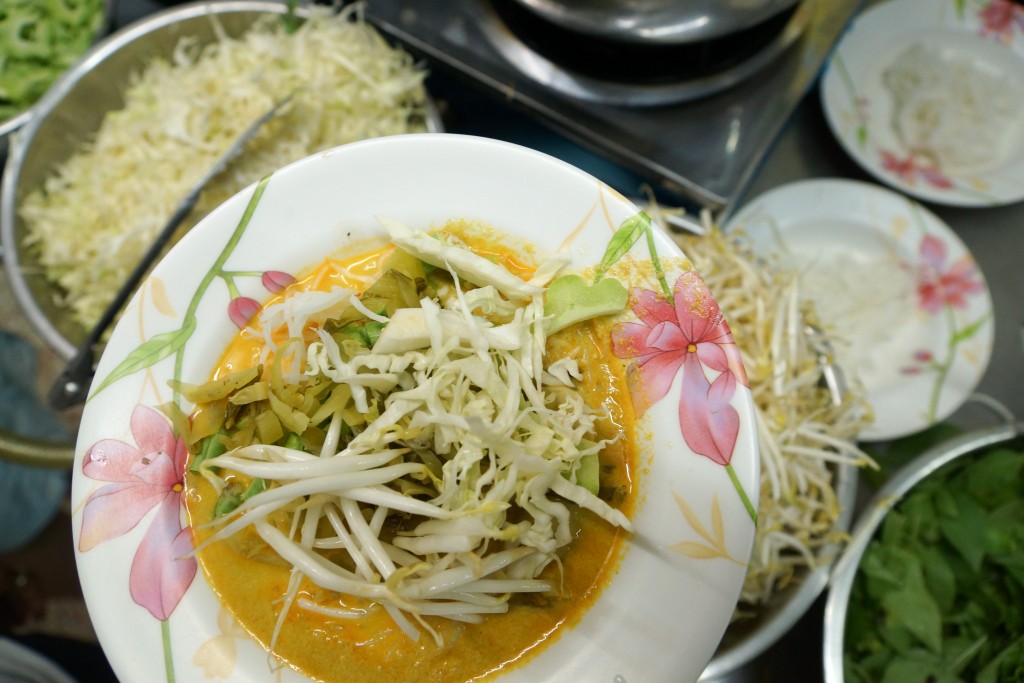 bowl of fermented noodles with curry sauce and vegetables