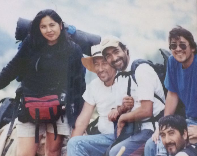woman in trekking gear with a group of men